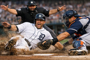 A thrilling play at the plate during a Detroit Tigers home game.