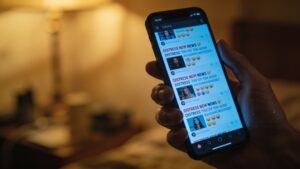 Smartphone showing constant news and social media alerts representing digital drivers of the global mental health crisis