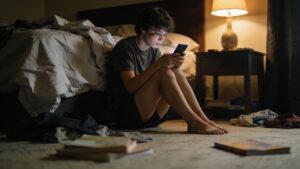 Young person alone in bedroom representing how the global mental health crisis disproportionately affects youth
