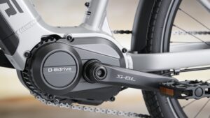 A close-up view of a high-performance mid-drive electric bike motor housing built directly into the frame.