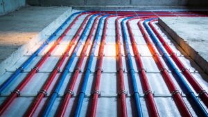 A detailed pattern of flexible radiant floor heating pipes installed across a residential room floor layout.