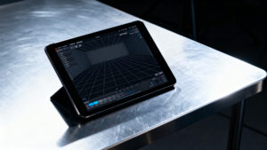 A digital tablet interface displaying a virtual production tracking application monitoring real-time camera position metrics on an active stage.