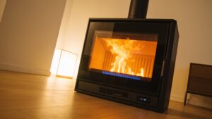 An advanced automated biomass pellet stove burning wood pellets cleanly behind a protective glass viewing window.