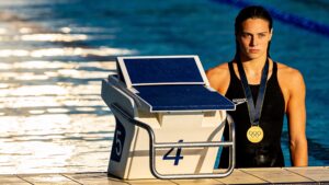 An swimmer on a diving block representing tapering protocols in periodization training frameworks in elite sports.