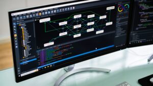 A software developer workstation monitor displaying automated multi-agent AI system workflows and code generation interfaces.