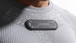 Close-up of a lightweight athletic compression shirt embedded with microscopic biometric sensor nodes and heart rate telemetry strips.