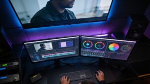 Video editor using a professional dual-monitor workstation with automated timeline assembly, generative color grading, and rotoscoping masks.