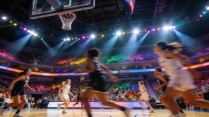 "Packed arena crowd watching a women's professional basketball game"
