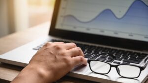 Laptop showing a price history chart that goes up and down, representing checking whether a sale is a real deal"