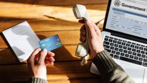 Person calling their bank and preparing to report a scam"