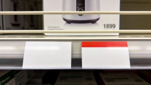 Shelf with price tags in a store, representing sale price labels.