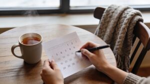 Person planning travel dates at a café table.