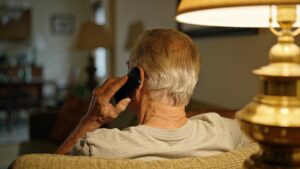 Person on the sofa taking an urgent phone call.
