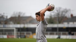 Player preparing to take a throw-in at the touchline.