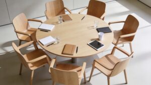 Six chairs around a round table in a bright meeting room.